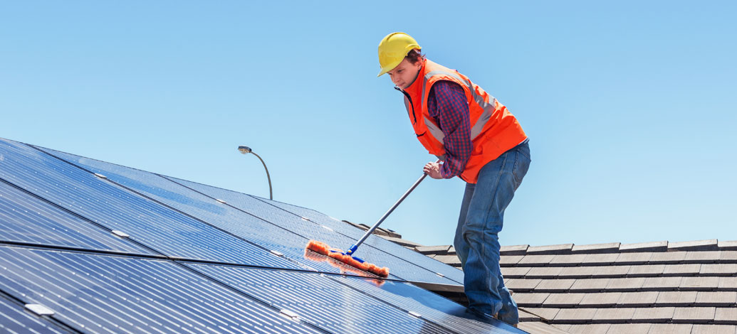Male Cleaner performing office clean with mop
